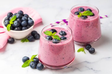 Glass of blueberry smoothie with mint and fresh berries  clipart