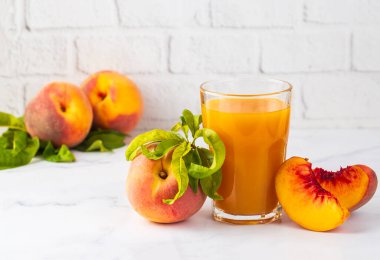 Natural peach juice in glass