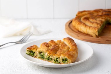 Traditional Turkish pastry with spinach. (Turkish Name: Ispanakli Kol Boregi, Bosnak boregi). Handmade pastry with spinach filling.