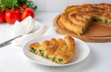 Traditional Turkish pastry with spinach. (Turkish Name: Ispanakli Kol Boregi, Bosnak boregi). Handmade pastry with spinach filling.