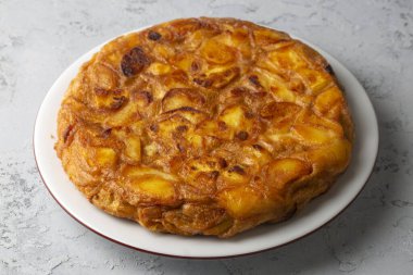 Spanish omelette with potatoes, typical spanish cuisine on gray concrete floor. Tortilla Espanola. Turkish name; Yumurtali patates