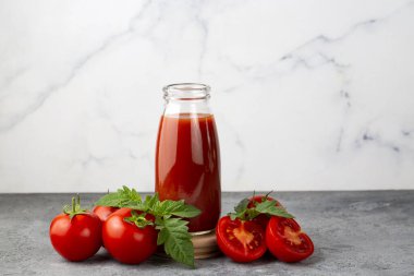 Tomato juice in a glass and fresh tomatoes