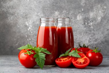 Tomato juice in a glass and fresh tomatoes