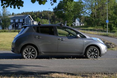 Tonsberg, Norveç - 2 Haziran 2023: Gri gri NISSAN LEAF, C segment elektrikli otomobil. Güneşli bir yaz gününde yeni bir araba. 