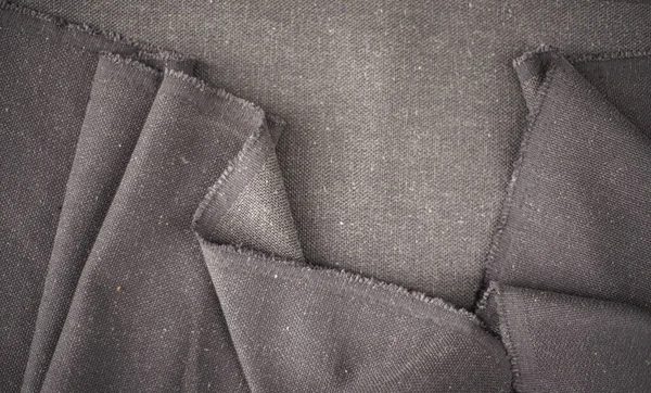 背景のための折目が付いている灰色の綿 衣類の生産のための生地の近く — ストック写真