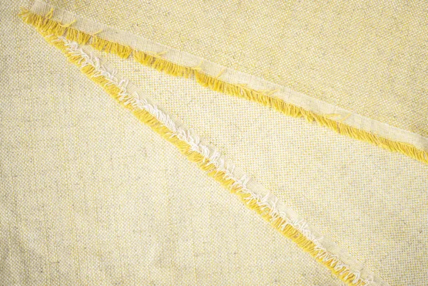 背景のためのフリンジエッジが付いている黄色いヴィンテージの綿 衣類の生産のための生地の近く — ストック写真