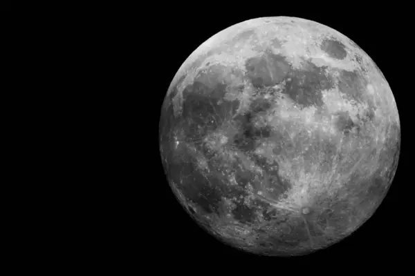 stock image A striking and captivating image of the full moon, showcasing its intricate surface details in a dark environment