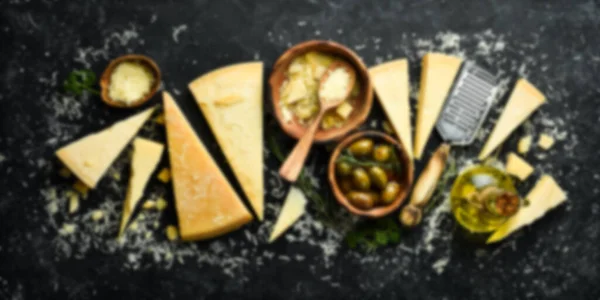 Defocused Food Background Set Hard Cheeses Cheese Knives Black Stone — Stock Photo, Image