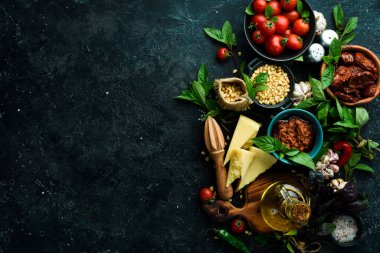 Domatesli Pesto Rosso sosu. İçindekiler: Domates, fesleğen, çam fıstığı, parmesan ve zeytinyağı. Beton bir arka planda.