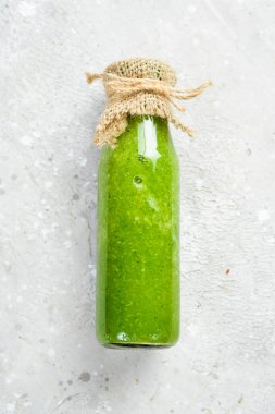 Şişe içinde yeşil sebze ve meyve suyu, kivi, ıspanak, elma ve kereviz. Vejetaryen yemeği. Metin için boş alan.