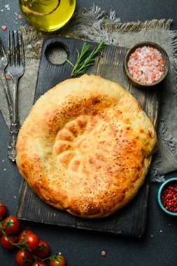 Koyu arka planda Pita ekmeği. Arapça, Lübnan ekmeği, geleneksel yemekler. Yakın plan, koyu arkaplan.