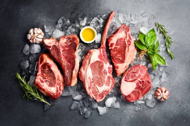 Baharatlı ızgara için çiğ Prime Angus bifteği: Tomahawk biftek, Ribeye, T-bone ve Ossobuco bifteği. Barbekü bifteği çeşitleri.