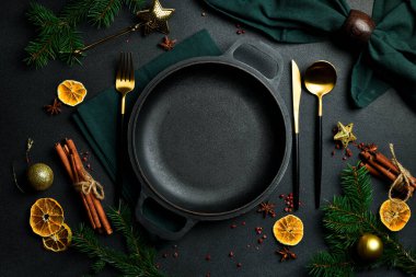 Sofrada bayramlık çatal bıçak takımı olan metal tava. Bedava fotokopi. Üstteki görünüm Koyu bir arkaplanda.