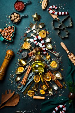 Noel fotoğrafı arkaplanda yemek ve pişirme malzemeleri var. Noel ağacı, kış baharatları ve mutfak aletleri..