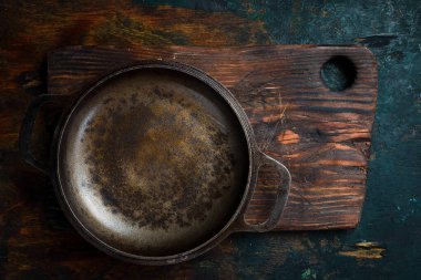 Tahta bir masada metal dökme demir tava. Metin için boş alan. Üst görünüm.