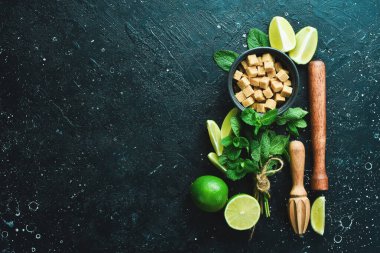 Mojito kokteyli yapmak için bar malzemeleri ve malzemeler. Siyah bir arka planda. Üst görünüm.