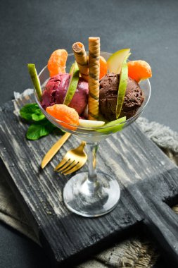 Meyve renkli dondurma ve bardakta meyve. Metin için boş alan. Kapat..