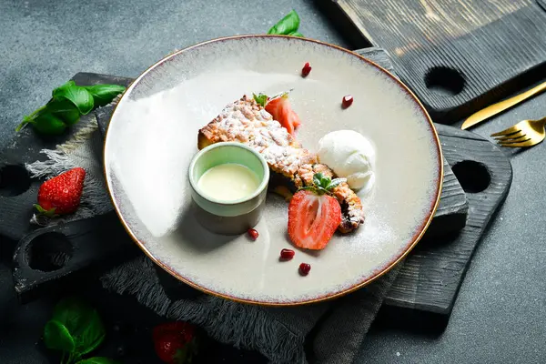 Bir kaşık dondurma ve kremayla birlikte bir parça haşhaşlı kek. Kapatın. Bir tabakta Siyah bir taşın arkasında.