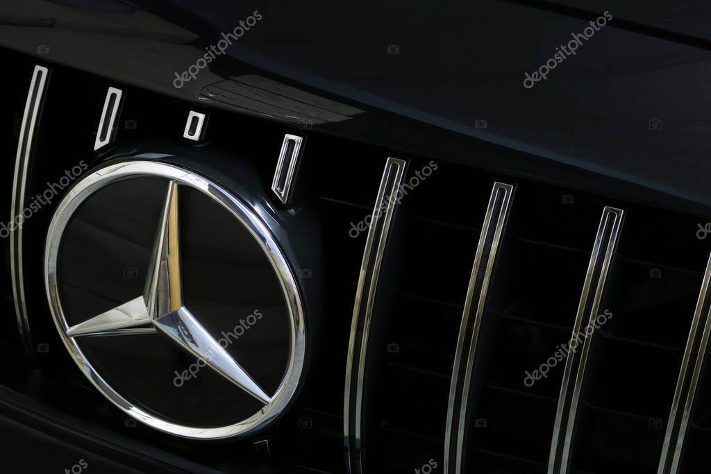 Mercedes Benz chromium grille with Benz star logo of black c class c200 coupe AMG model on the black background