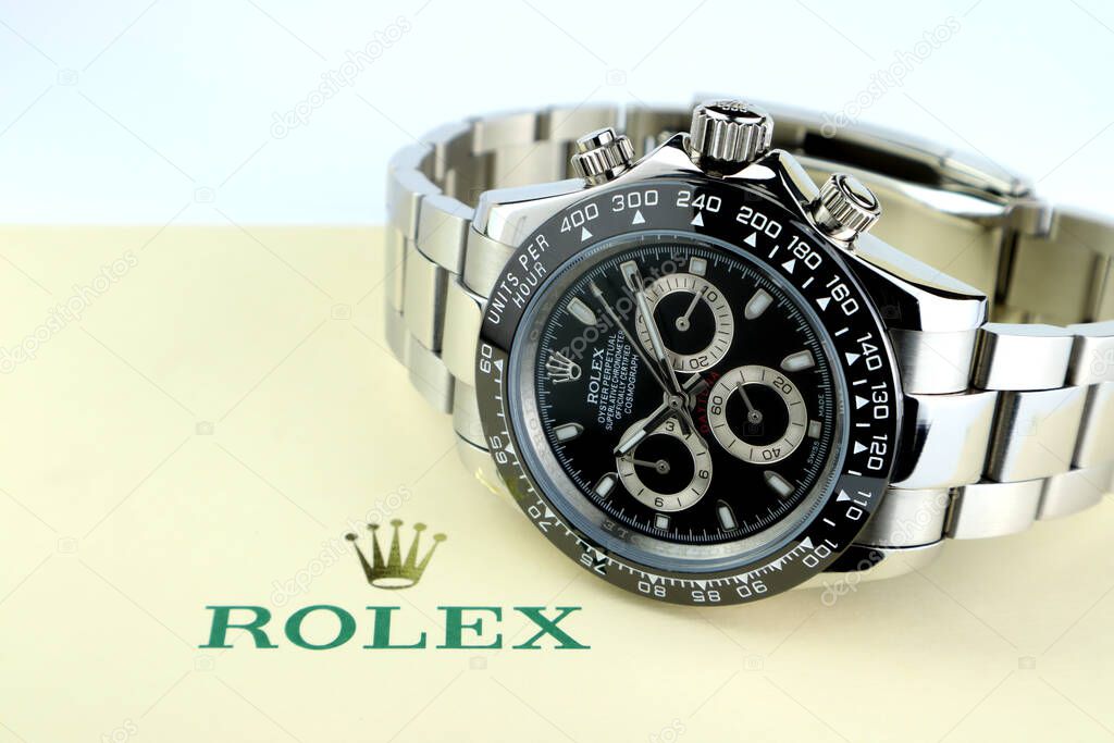 Rolex vintage wristwatch ceramic bezel model Cosmograph Daytona display on background of ivory package with Rolex crown logo on white table in luxury watch shop