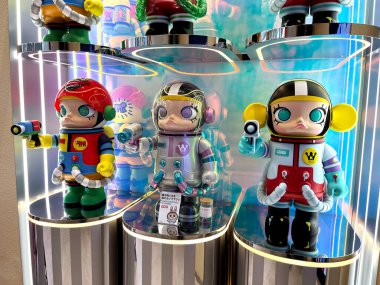 art toys mega space Molly 1000% collection from Pop Mart blind box collectable cute toys design of Hong Kong artist display on mirror glass shelf in Popmart store at Harajuku , Japan clipart