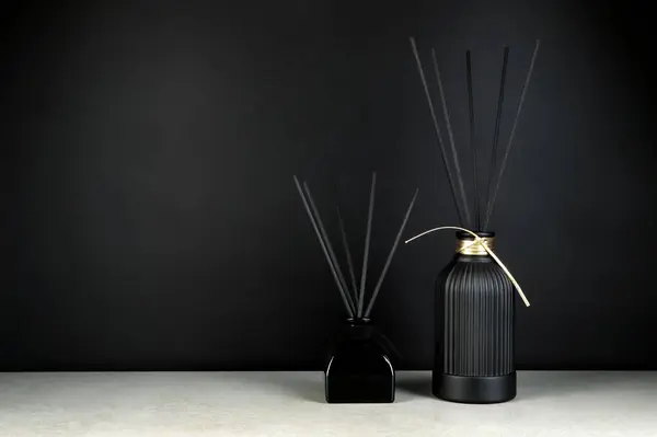 stock image luxury aroma scent reed diffuser black glass bottle are on grey stone table to creat romantic and relax ambient in bedroom with black cement wall background in the morning of happy valentine day