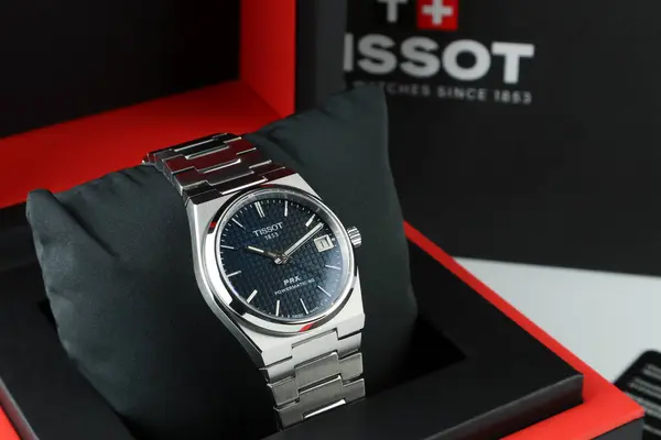 stock image nice vintage design stainless steel watch , brand Tissot PRX blue dial powermatic model 35 mm display in luxury box package on white shelf with card , brand bag and warranty book in authorized store