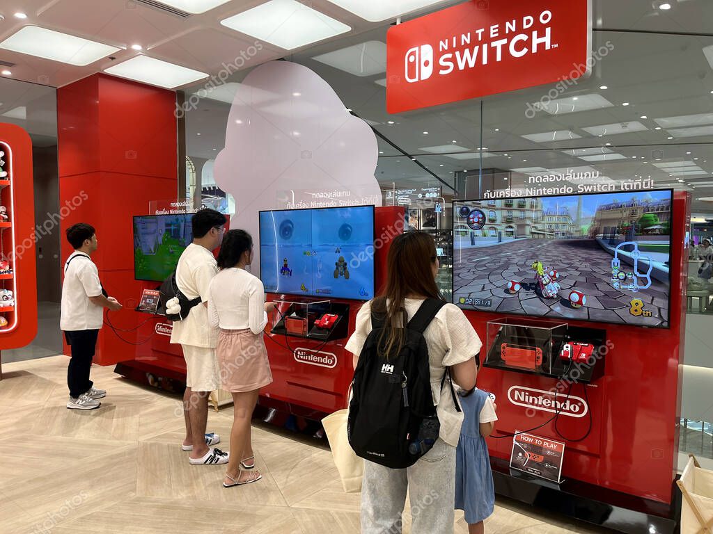 Customers playing Nintendo switch game in Nintendo Authorized store by Synnex in Siam Paragon shopping mall , store in Thailand full of games, character dolls, game accessories , Nintendo Switch 2