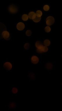 Dikey İnce Işıklar Siyah 4K Döngü 'de hareket eden kırmızı turuncu ışık küreleri hareketli ve dikey oran döngüsünde ince kaymalarla koyu bir atmosferde hareket eder.. 