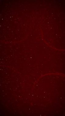 Dikey Noel Parıltısı Kar Döngüsü 4K Döngüsü ince girdaplar ve parçacıklar ekran içinde ve dışında dikey oran döngüsü içinde hareket eden koyu kırmızı bir atmosfere sahiptir.. 