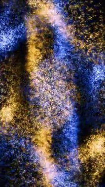 Dikey Mavi ve Altın Parçacık Gece Dansı 4K döngüsünde mavi ve altın parçacıklar birbirine dikey oran döngüsü içinde karışır ve dans eder..