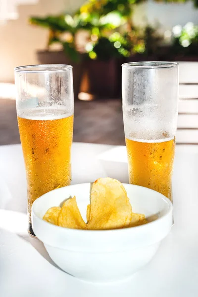bowl with chips and two glasses of beer in a bar terrace in Tenerife. Canary Islands. Spain