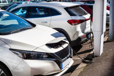 electric cars charging at a modern gas station on a sunny day