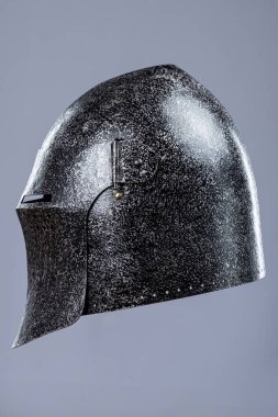 Koyu Çelik Ortaçağ Şövalye Miğferi. Savaş eskimiş baş koruması ve dar göz yarıkları..