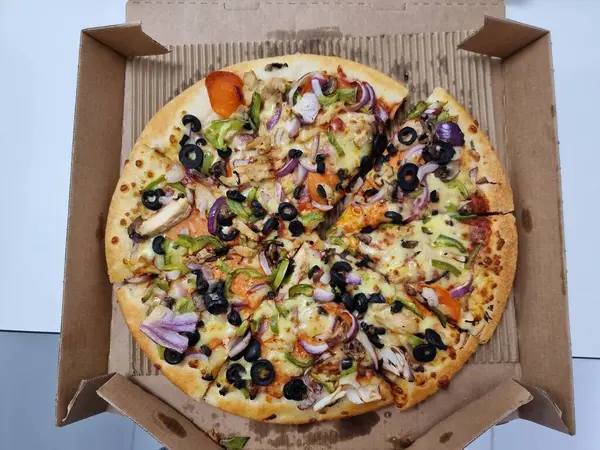 a closeup shot of a pizza in cardboard box