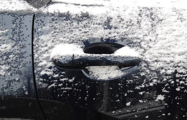 Dark Blue Car Door Handle Covered With Snow And Ice Stock Photo