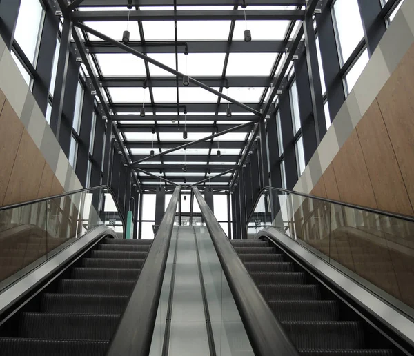 stock image Two underground stairs escalators to the car parking on the roof of the business center 