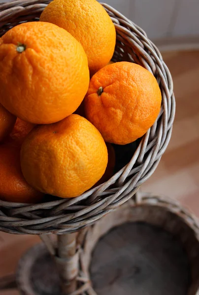 Empty Wicker Baskets Under One Basket Full Of Fresh Whole Mandarin Fruits