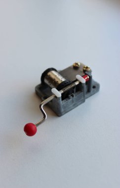 Hand Cranked Music Box On White Surface Vertical Stock Photo