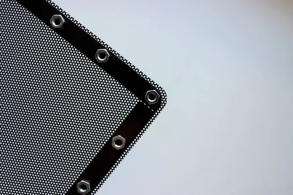 Part Black Metal Perforated Panel Shiny Nuts Edges White Background — Stockfoto