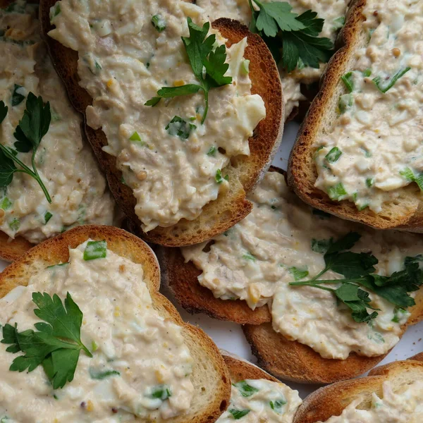 stock image Egg pate with greens on crispy white bread toasts square stock photo