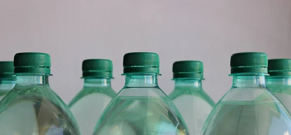Green Caps Plastic Bottles Filled Water Closeup Side View Stock — 스톡 사진