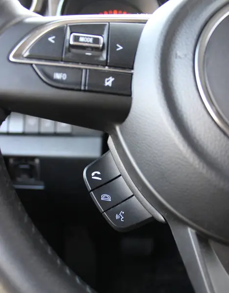 Hands Free Phone Buttons Under Steering Wheel In Car Closeup View