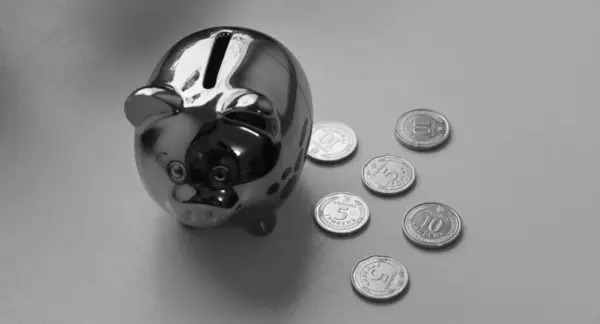 Silver Painted Piggy Money Box With Scattered Ukrainian Coins Isolated On White