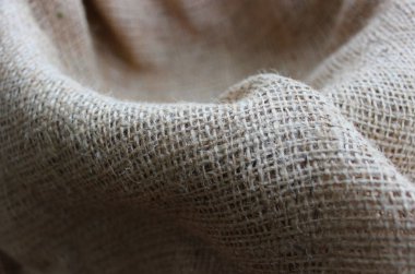 Arka planlar için, dalgalı kıvrımlı büyük örgü kumaş kumaş desenli fotoğraf deseni. Seçici ve kısmi odak çuval bezi arkaplanı