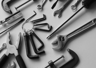 Variety Mechanic Tools With Black Handles Isolated On White Surface. Grayscale Stock Photo For Tools Backgrounds clipart