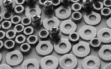 Flat Surface Of Scattered Bolts, Nuts And Washers Monochrome Image. Stock Photo For Metalware Backgrounds clipart
