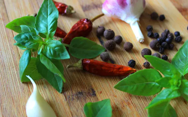 Stock image Spices for preparing marinade for meat dishes on wooden cutting board 