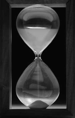 Hourglass Counting Time With Pouring Sand Angle View Black And White Concept Image   clipart