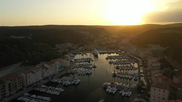 stock image  City bay with moored yachts and boats at sunset time aerial photo